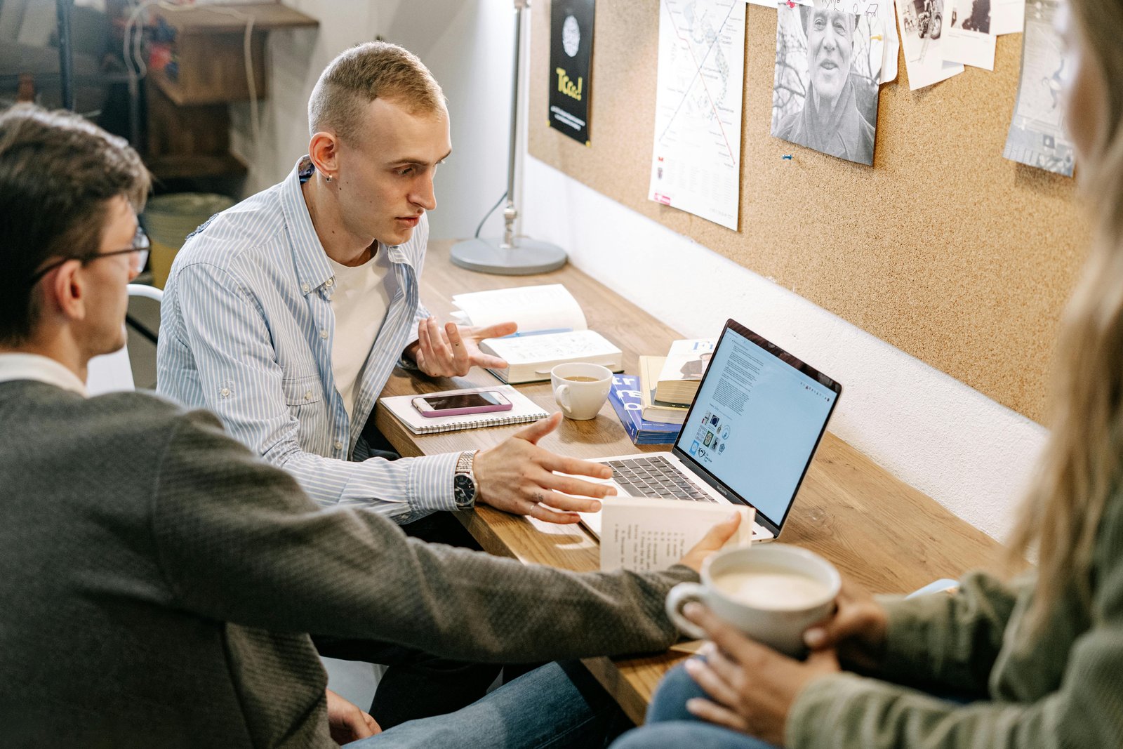 Team discussing  while staring at a laptop- Most Affordable Keyword Research Tool for 2023